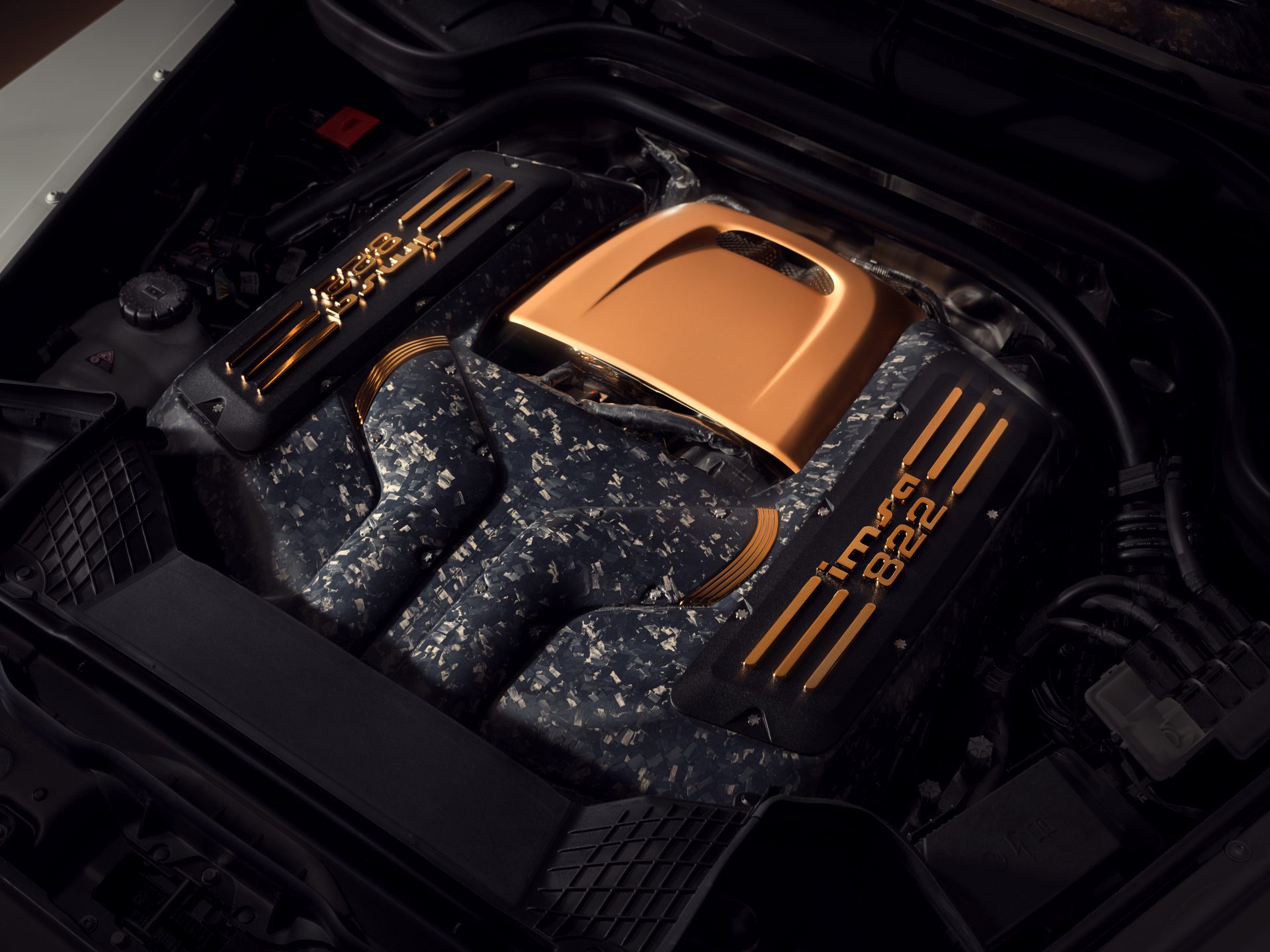 Engine bay of the IMSA Precision 822 with gold tone and carbon